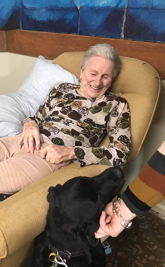 Resident enjoying a dog's visit